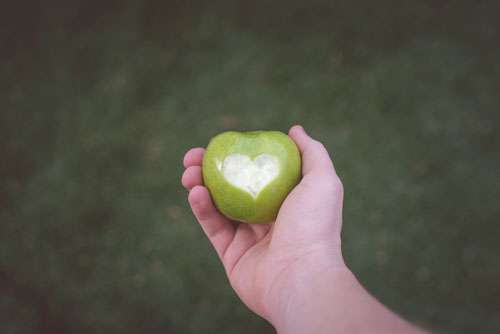 Man Holding Green Apple With Love Heart