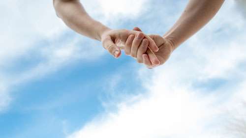 Couple Holding Hands In Love  With Blue Sky