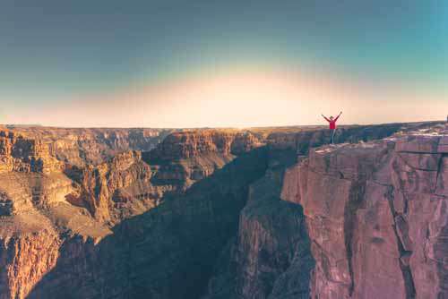 Man Celebrating At The Grand Canyon While Travelling