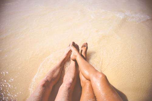 Cute Couples Feet Playing In Sea