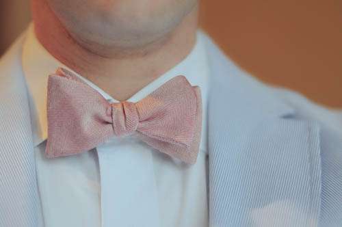 Self Tied Pink Bowtie On Man With Blue Jacket