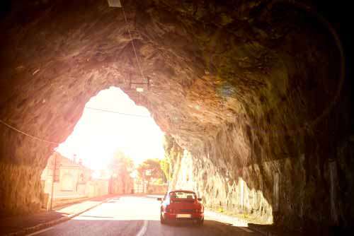 Vinatage Porsche Car Driving Through Tunnel