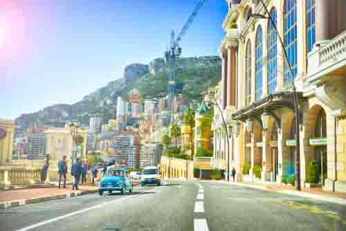 Street In Monaco  With Cars, People And European Buildings