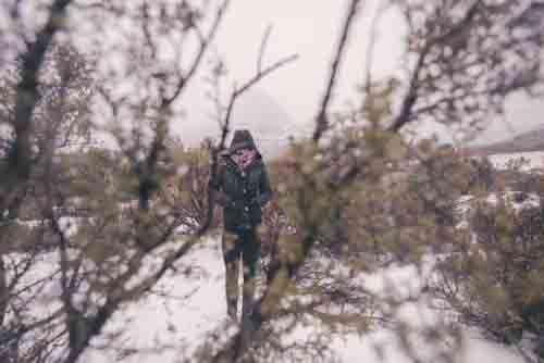 Girl On Mountain Standing In Snow