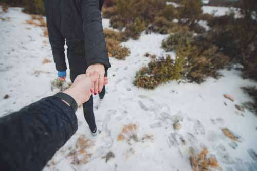 Hiking And Holding Hands in Winter Snow