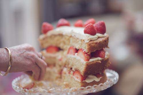 Hand Taking Strawberrys And Cream Cake