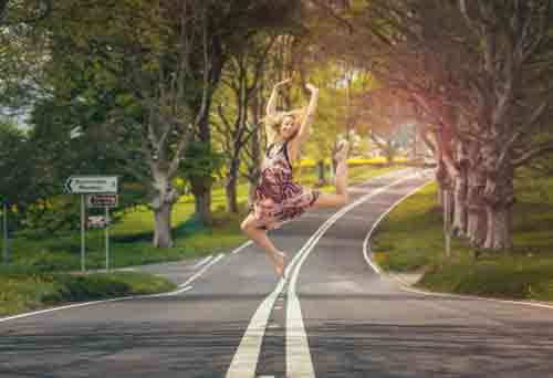 Dancing Girl Jumping In Street Looking Happy