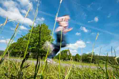 Man Jogging Through Field With Motion Blur