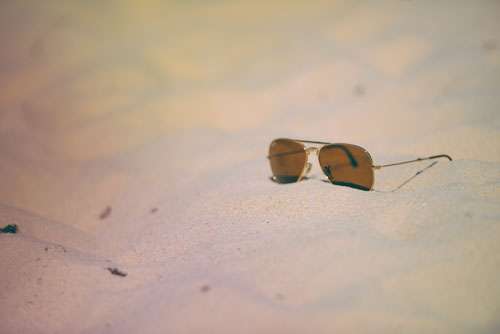 Trendy Sunglasses In The Sand On A Beach