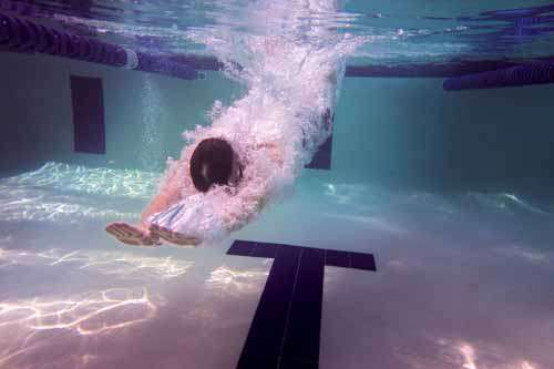 Man Diving Into Swimming Pool