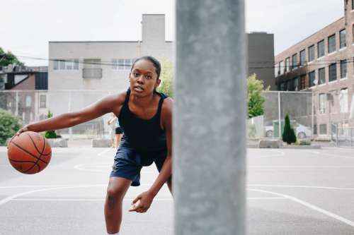 Young Woman Practices Her Dribbling Skills Photo