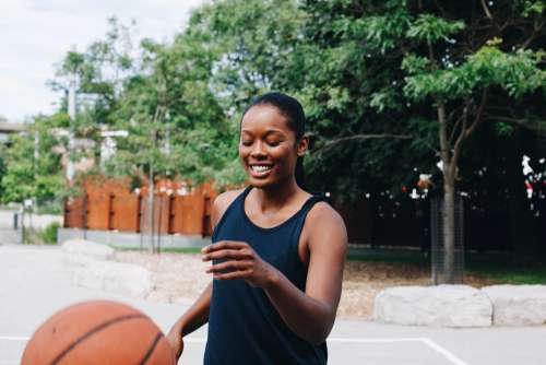 Woman Playing Basketball In The Street Photo