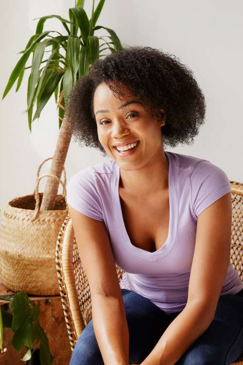 Smiling Model Surrounded By Plants Photo