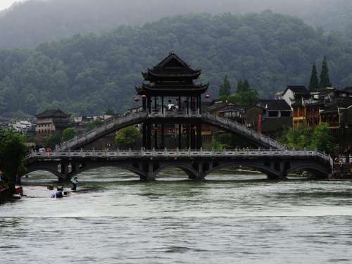 Oriental Bridge Beneath Mountains Photo