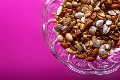 Close Up Of Nuts On Pink Background Photo
