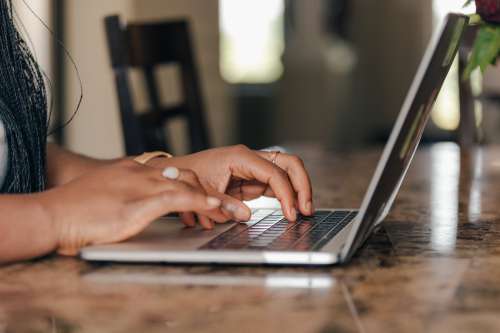 A Pair Of Hands Typing Away Photo