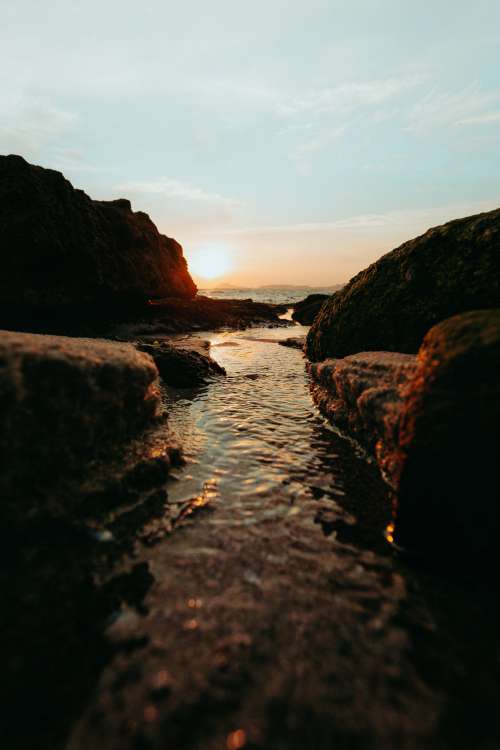 Stream Meets The Sea At Sunset Photo