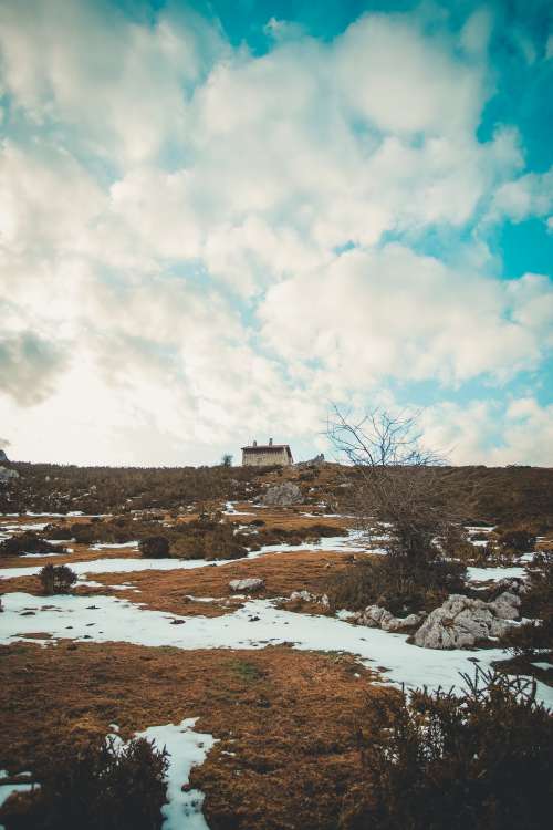 Distant House Within Snowy Wilderness Photo