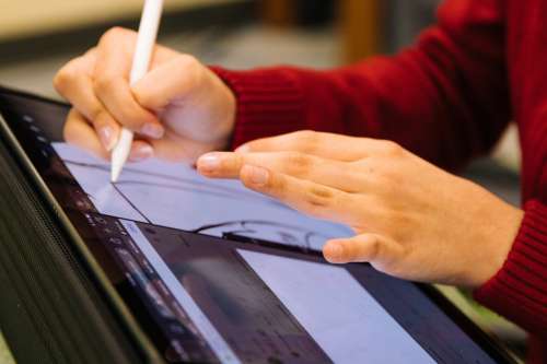 Person Using Pencil To Design On Tablet Photo