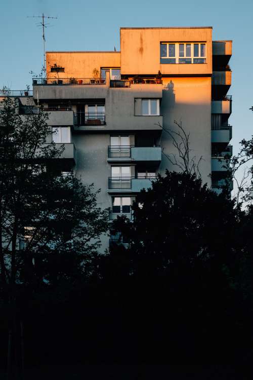 Sunset Casts Shadows On Building And Trees Photo