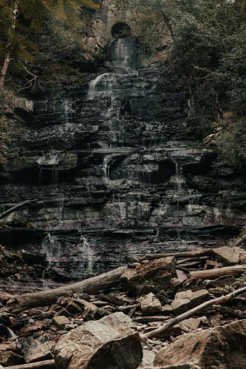 Waterfall Spills Over Jagged Rock Face Photo