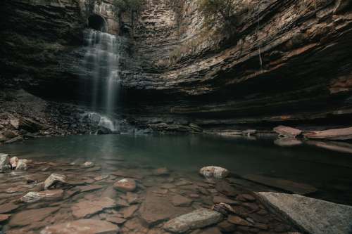 Waterfall Cascading Through Cave Tunnel Photo
