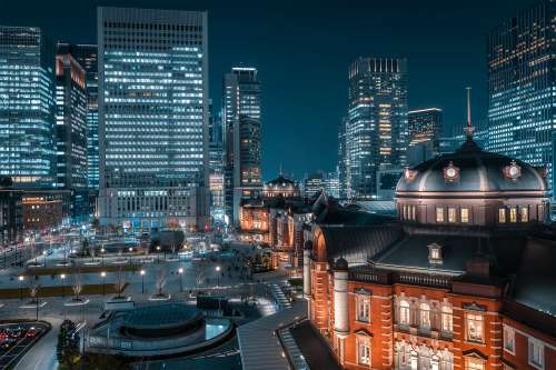 Illuminated CIty Building Surrounded By High Rises Photo