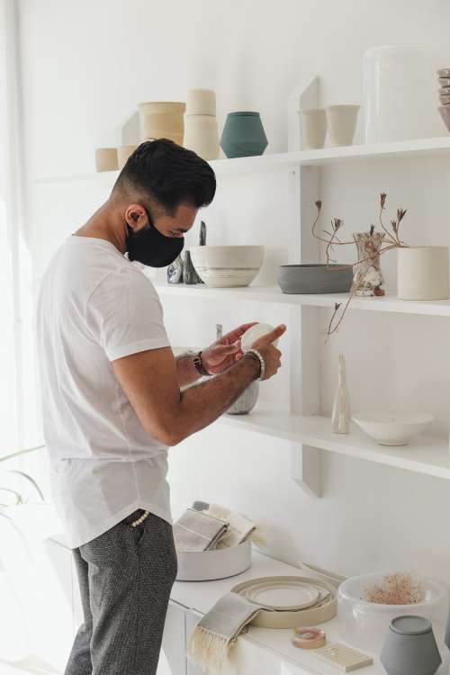 Young Man Looks At Merchandise In Local Store Photo