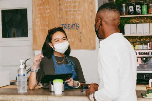 Man Orders Coffee While Wearing Face Mask Photo