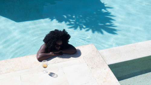 Young Woman standing at the edge of a swimming pool