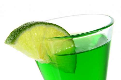 green cocktail with lime slice
