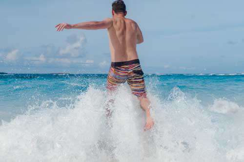 Man Running Into Ocean In Summer