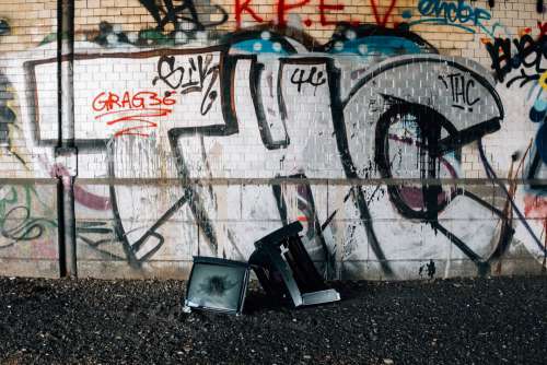 Smashed TV And Graffitied Wall Photo