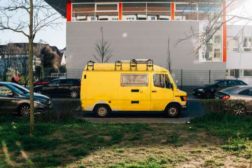 Yellow Van Brightening Nearby Parking Spots Photo