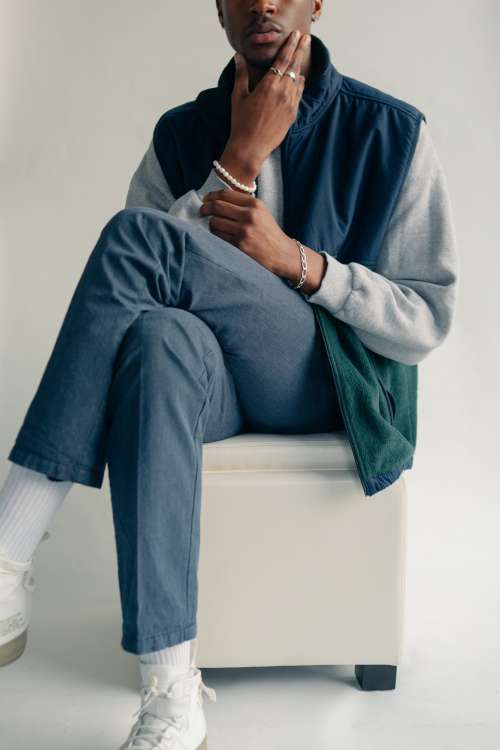 Male Model Cross Legged On White Cushion Photo