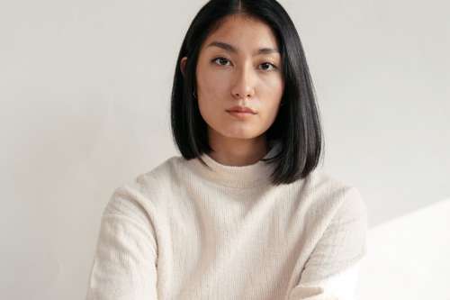 Close Up Of Model Wearing Cream Sweater Photo