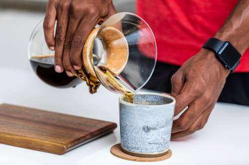 Fresh Cup Of Black Coffee Being Poured Photo