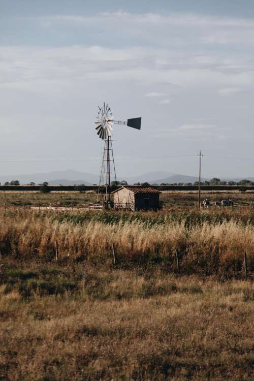 Small Rural Building With Windmill Photo
