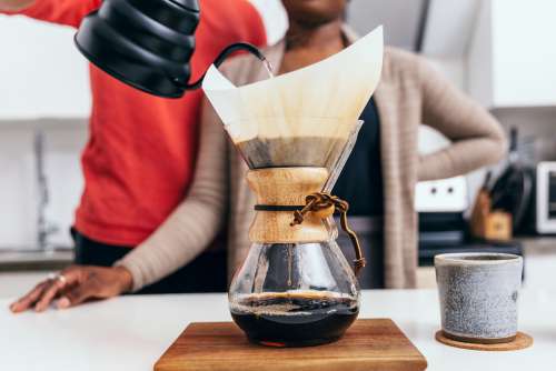 Couple Stand Together Pouring Coffee Photo