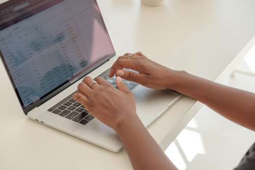 Store Owners Hands Typing Away Photo