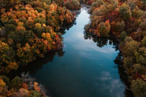 Winding River Through Orange And Red Trees Photo