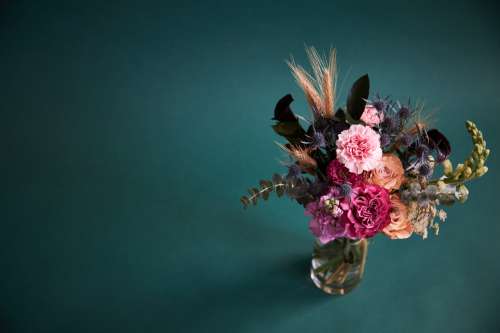 Off Center Vivid Floral Bouquet In Clear Vase Photo