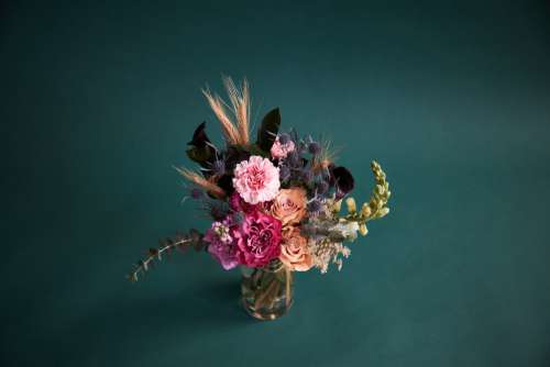 Vivid Floral Arrangement On Dark Teal Photo