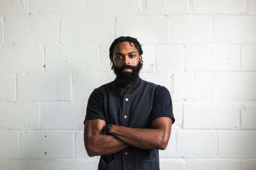 Man With Folded Arms Poses For Camera Photo