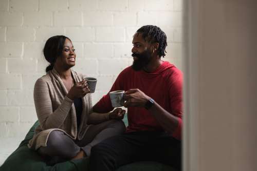 Young Couple Laugh Together With A Coffee Photo