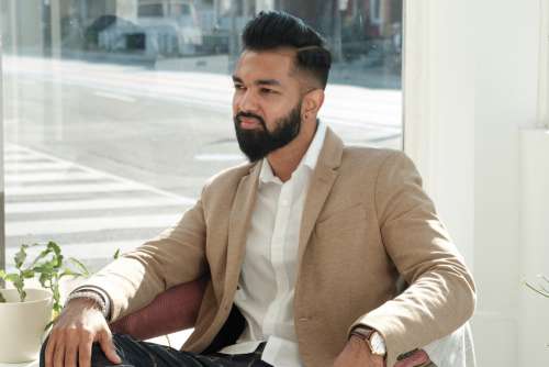 Dapper Young Man Sits In Store Window Photo