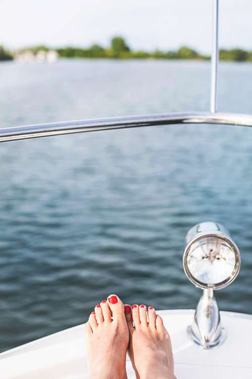 Feet Rest On A Boat Bow Photo