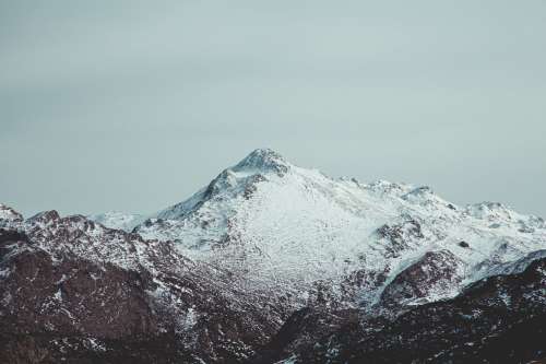 A Lonely Mountain Covered In Snow Photo