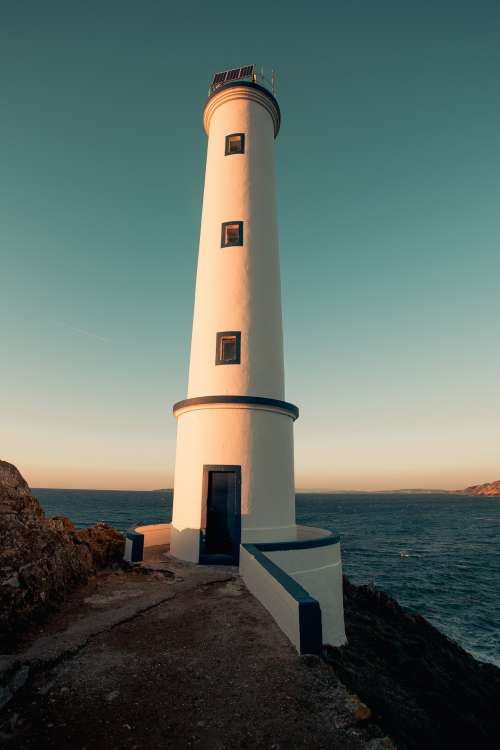 Sunset Casts Shadows On Lighthouse Photo