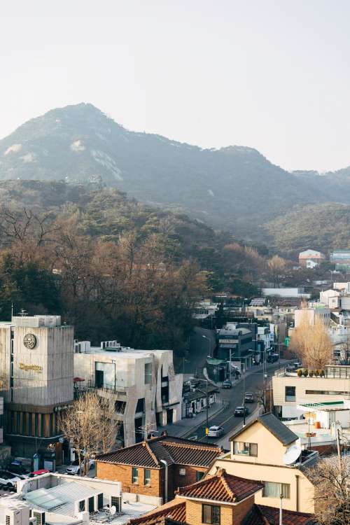 A Town Nestled Beneath A Mountain Photo